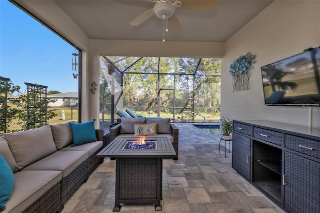 view of patio with an outdoor living space with a fire pit and a lanai