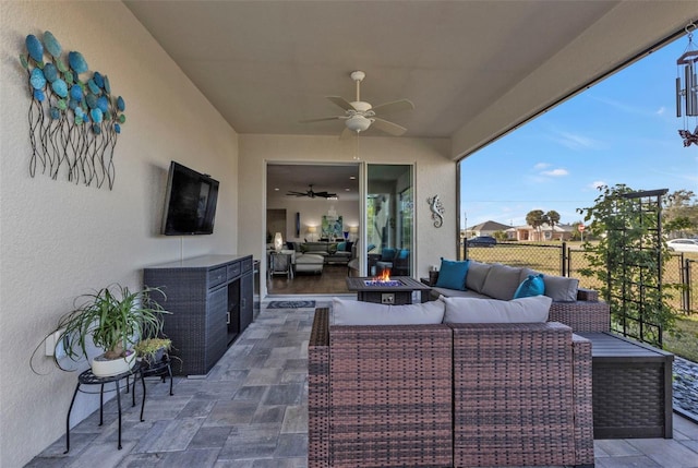 view of patio / terrace featuring an outdoor living space with a fire pit and ceiling fan