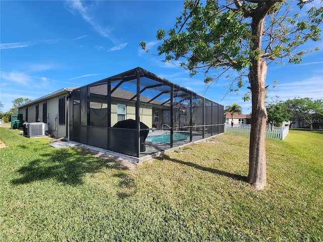 exterior space featuring central AC, a fenced in pool, and glass enclosure