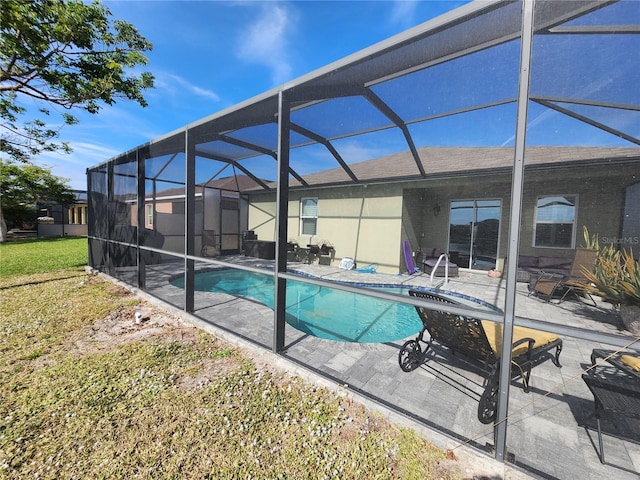 view of pool with glass enclosure and a patio area