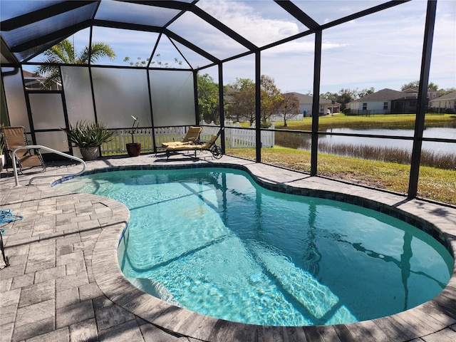 view of swimming pool with glass enclosure, a water view, and a patio