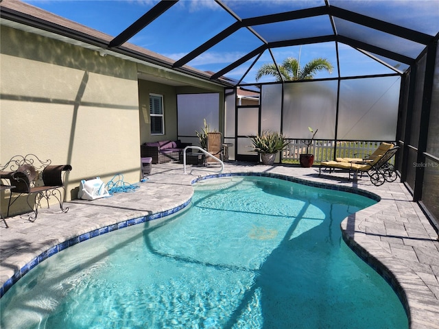 view of pool featuring a patio area and glass enclosure