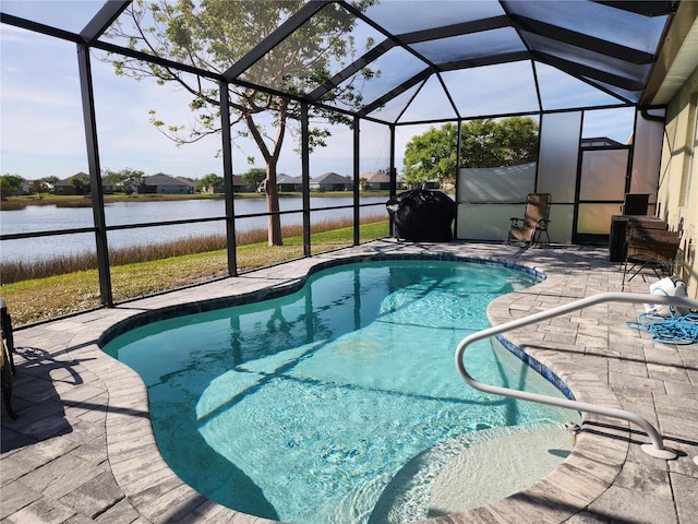 view of swimming pool with a water view, a patio area, and a lanai