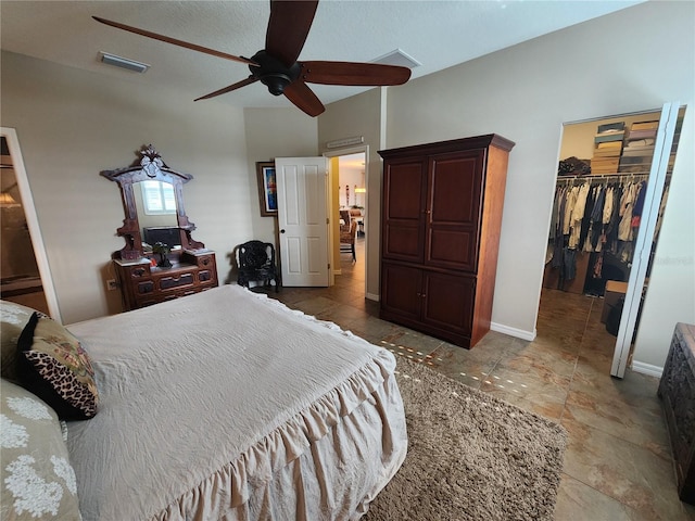 bedroom with ceiling fan, a spacious closet, and a closet