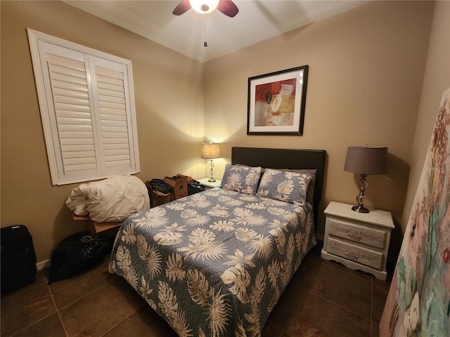 tiled bedroom featuring ceiling fan