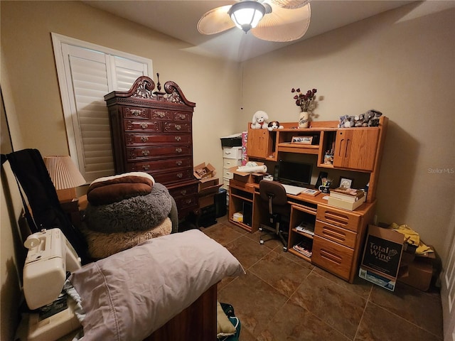 office area featuring dark tile patterned flooring and ceiling fan