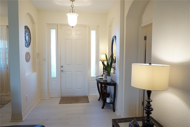25115 Esmeralda Ct, Punta Gorda, FL 33955 - foyer entrance with wood finished floors, healthy amount of natural light, and arched walkways