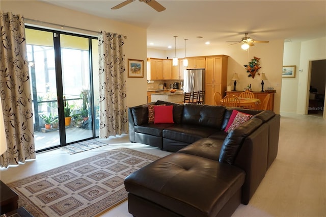 living room with ceiling fan and light hardwood / wood-style flooring