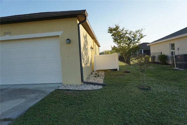 view of property exterior with a yard, a garage, and central air condition unit