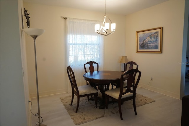 dining room featuring light hardwood / wood-style flooring and a notable chandelier