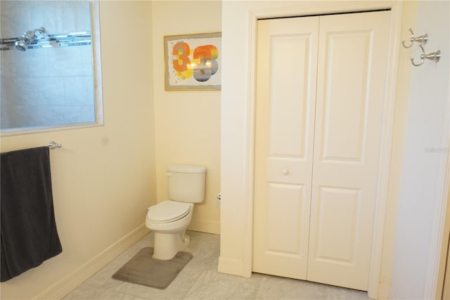 bathroom with tile patterned flooring and toilet