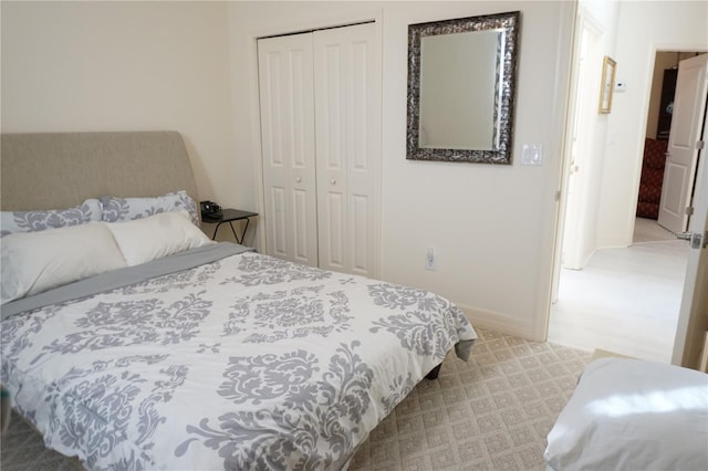 bedroom featuring light carpet and a closet