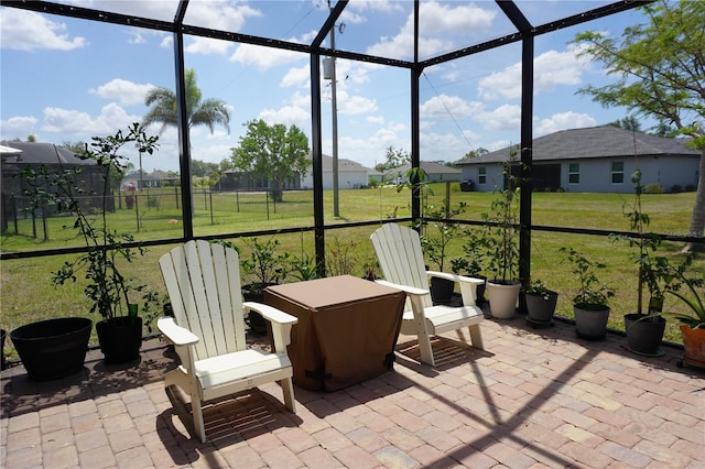 sunroom / solarium featuring a residential view