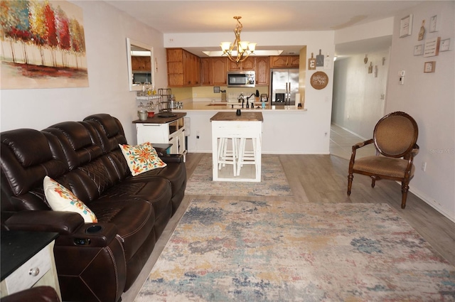 living room with wood-type flooring and a notable chandelier