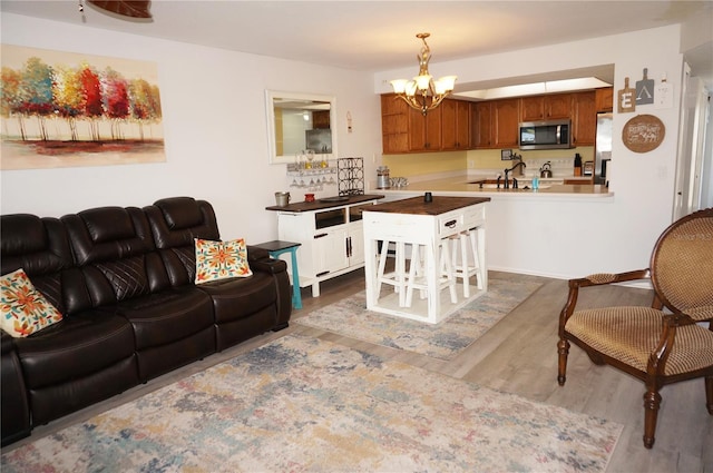 living room with hardwood / wood-style floors and a notable chandelier