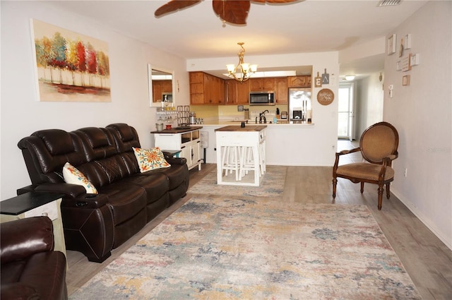 living room with hardwood / wood-style floors and a chandelier