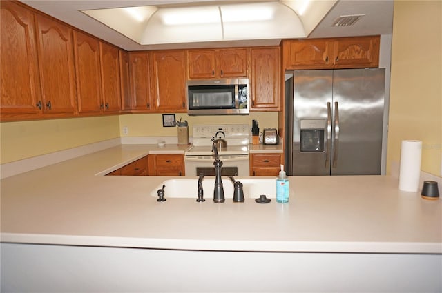 kitchen featuring kitchen peninsula and appliances with stainless steel finishes