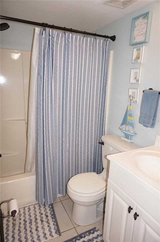 full bathroom with shower / tub combo, vanity, tile patterned floors, and toilet