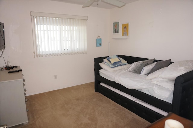 bedroom featuring light colored carpet and ceiling fan