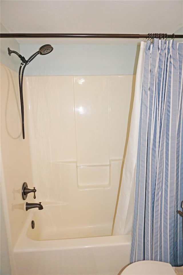 bathroom with shower / bath combo with shower curtain