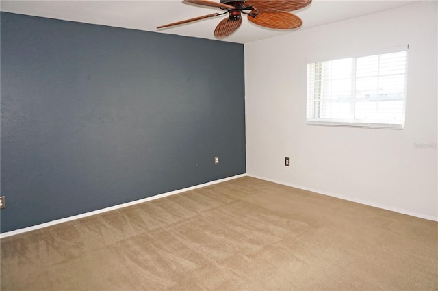 carpeted spare room with ceiling fan