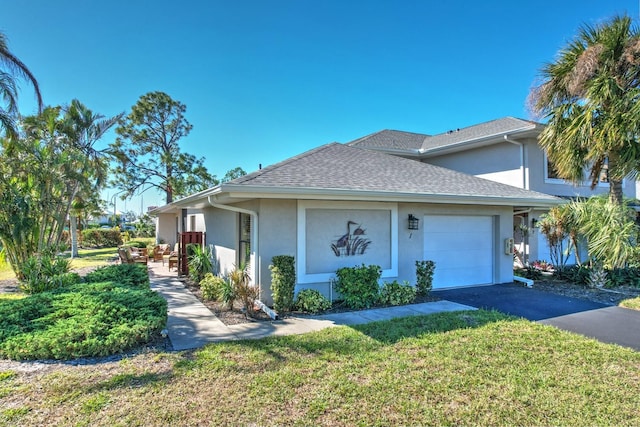 view of front of property featuring a front lawn and a garage