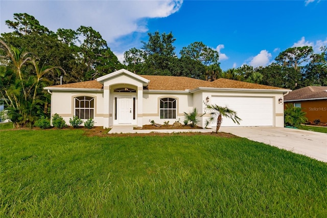 view of front of home with a front lawn and a garage