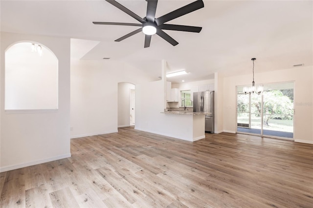 unfurnished living room with light hardwood / wood-style flooring, ceiling fan with notable chandelier, and sink