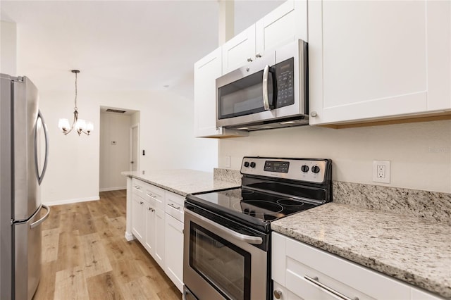 kitchen with lofted ceiling, light wood-type flooring, white cabinetry, and stainless steel appliances