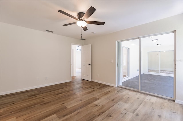 empty room featuring ceiling fan and light wood-type flooring