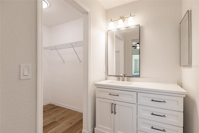 bathroom featuring ceiling fan, vanity, and hardwood / wood-style flooring