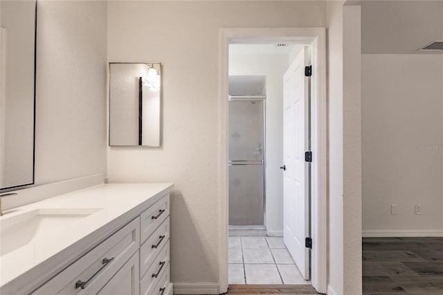 bathroom with vanity, wood-type flooring, and an enclosed shower