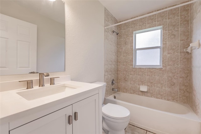 full bathroom with tile patterned floors, vanity, toilet, and tiled shower / bath combo