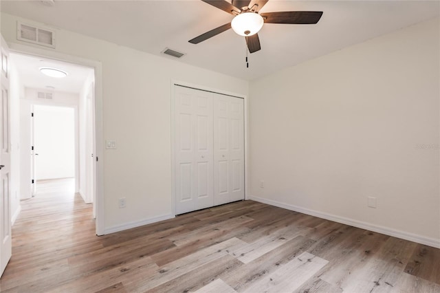 unfurnished bedroom featuring ceiling fan, a closet, and light hardwood / wood-style floors