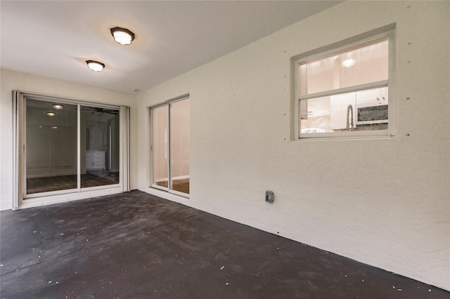 unfurnished room with concrete flooring