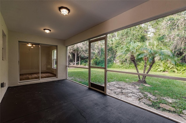 unfurnished sunroom featuring ceiling fan