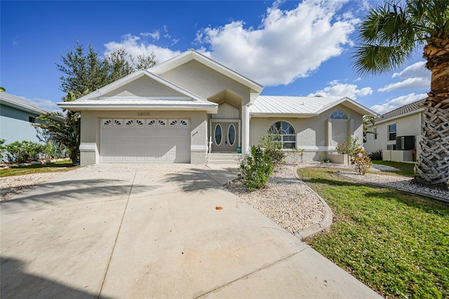 single story home featuring a garage and a front yard