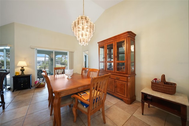 tiled dining space with a chandelier and lofted ceiling