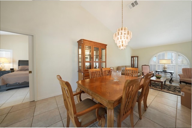 dining room with high vaulted ceiling, an inviting chandelier, and light tile patterned flooring