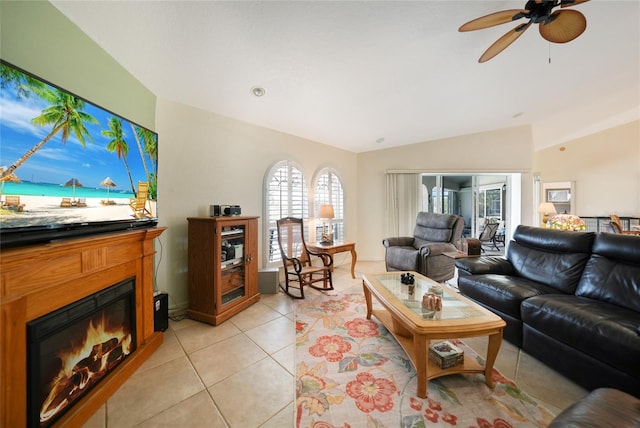 tiled living room with ceiling fan and vaulted ceiling