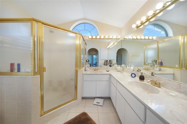 bathroom with tile patterned flooring, vanity, a shower with door, and lofted ceiling