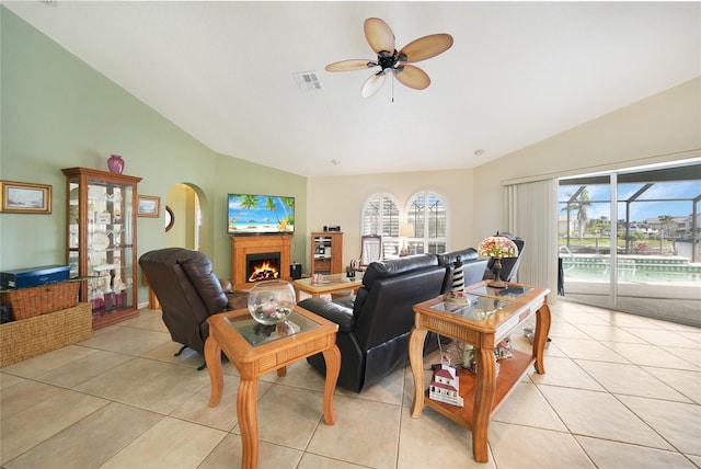 tiled living room featuring vaulted ceiling and ceiling fan