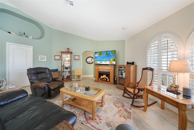 tiled living room featuring vaulted ceiling