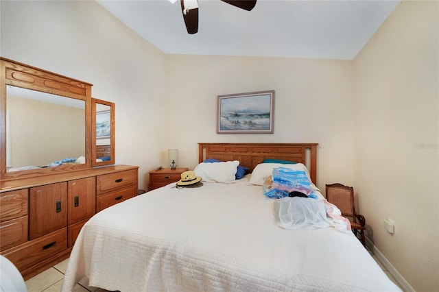 bedroom featuring light tile patterned floors, vaulted ceiling, and ceiling fan