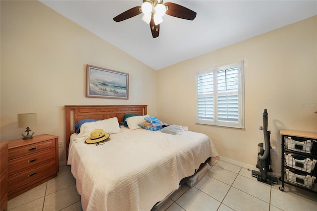 bedroom with light tile patterned floors, vaulted ceiling, and ceiling fan