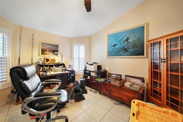 office featuring ceiling fan, light tile patterned floors, and vaulted ceiling