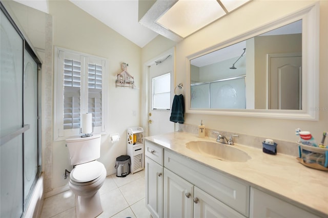 bathroom featuring tile patterned floors, vanity, toilet, and lofted ceiling