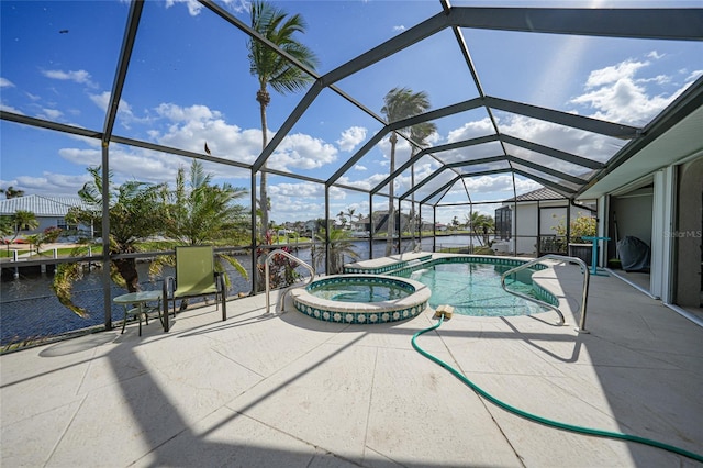 view of pool featuring glass enclosure, an in ground hot tub, a water view, and a patio