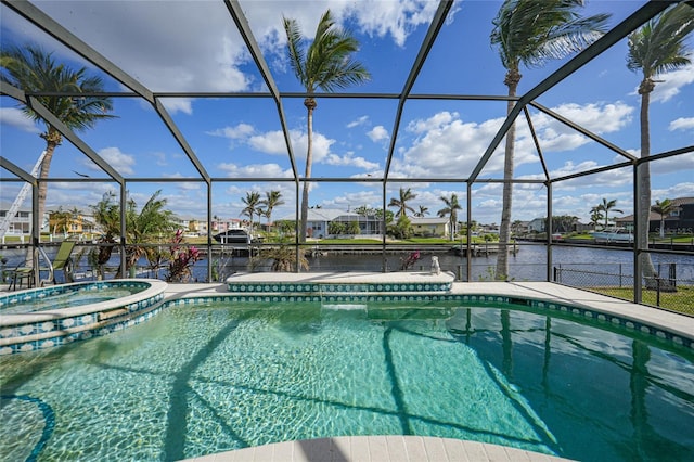 view of swimming pool featuring glass enclosure, a water view, and a boat dock