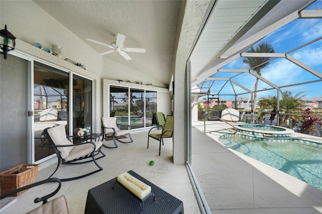 view of patio / terrace featuring ceiling fan, a swimming pool with hot tub, and a lanai